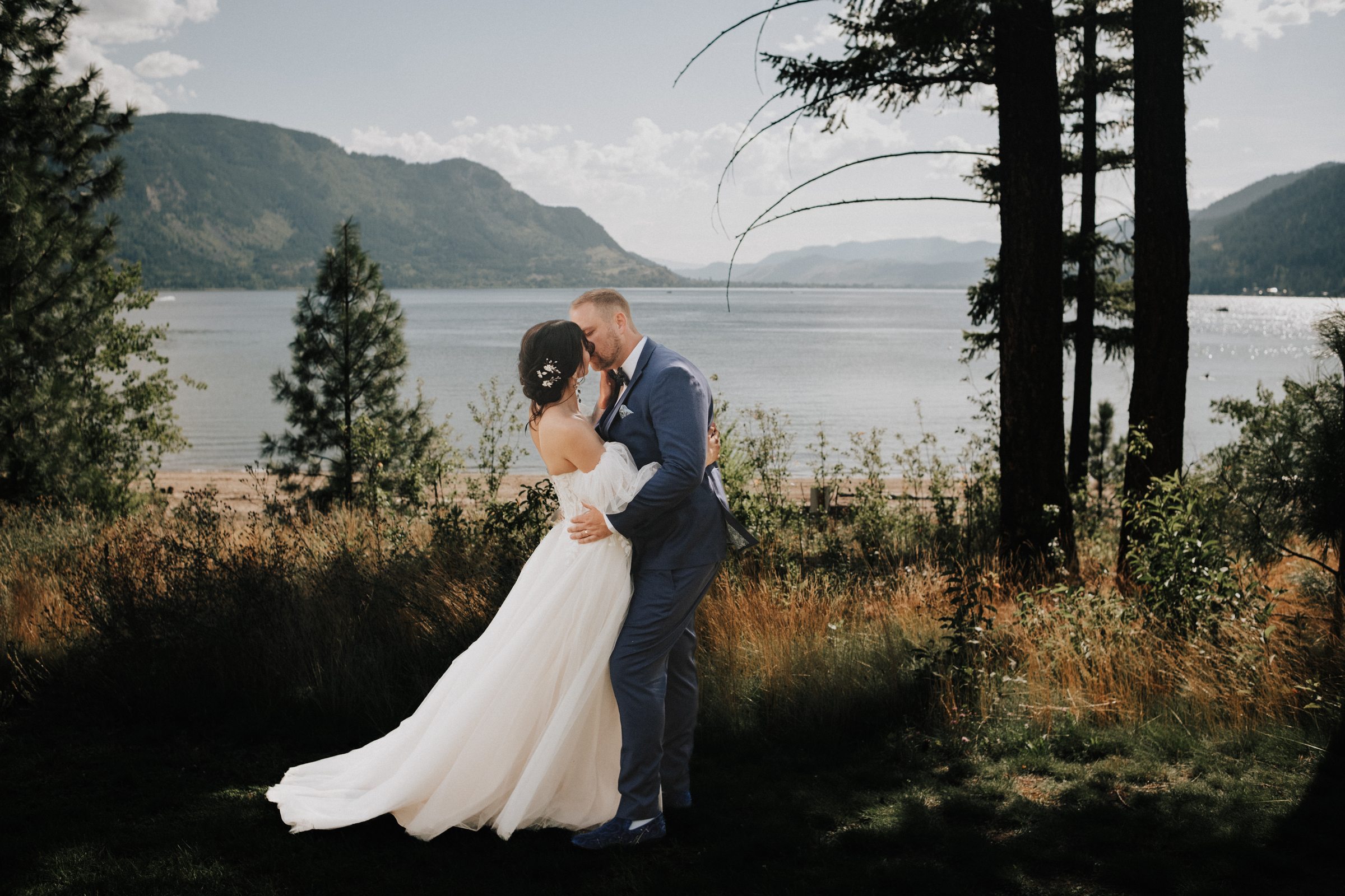 Wedding couple on a lakeside shoreline photographed by Barad Studio